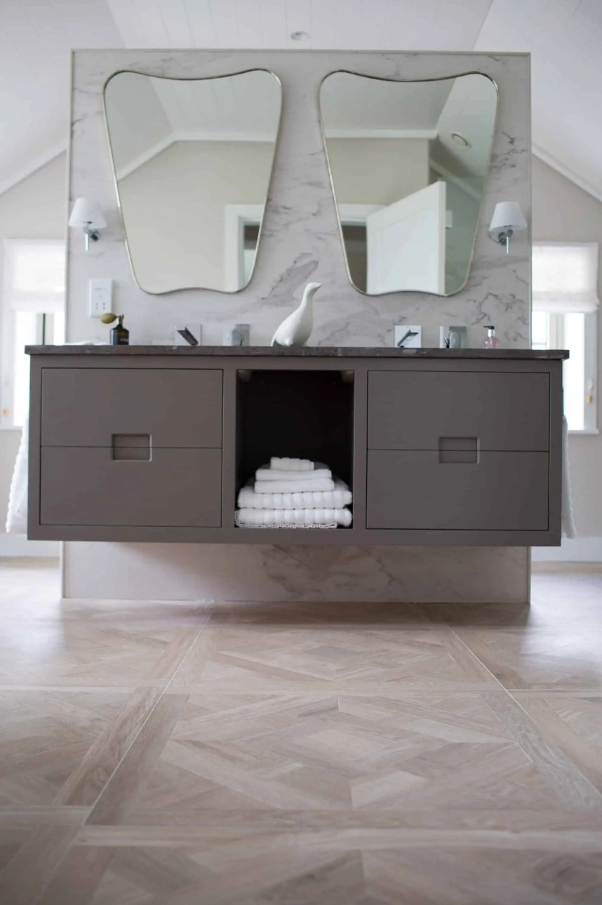 Floating double vanity on a marble-effect porcelain feature wall