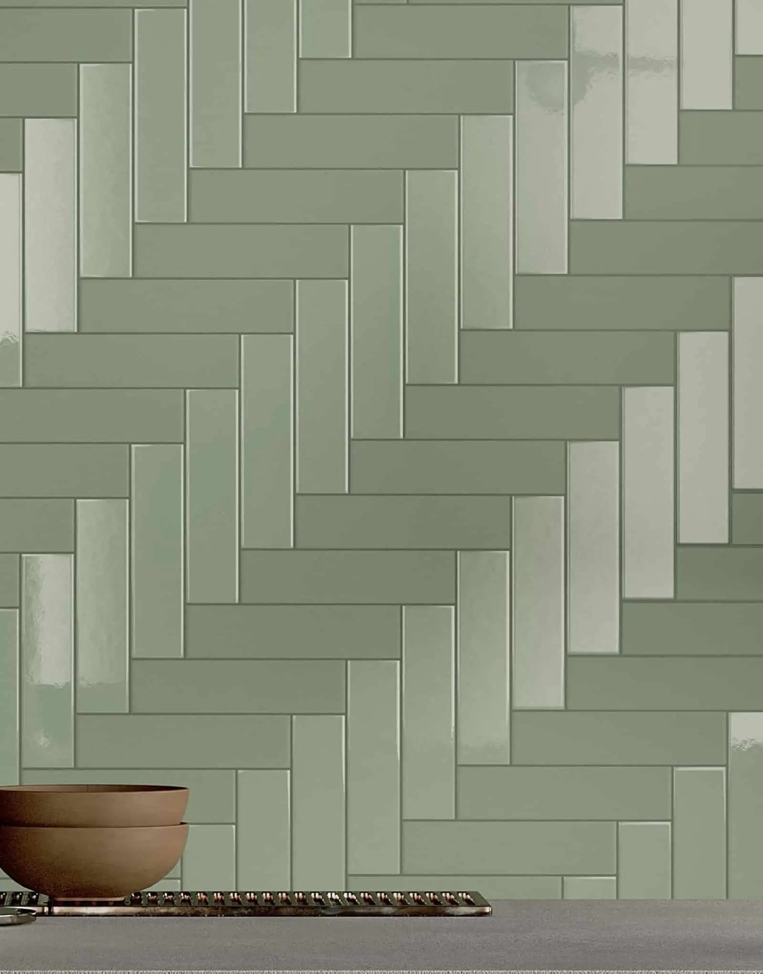 Sage green tiles in herringbone, alternating gloss and matt